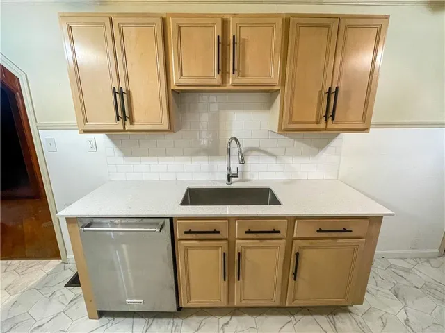 a close view of sink and cabinets