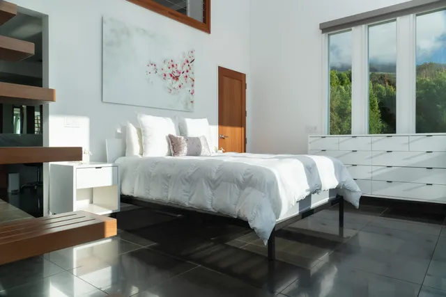 a bedroom with a bed and a flat screen tv