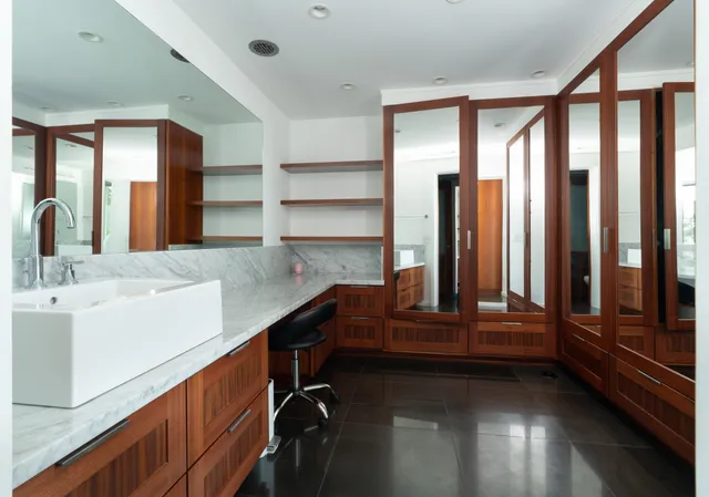 a bathroom with a tub a sink and a large mirror