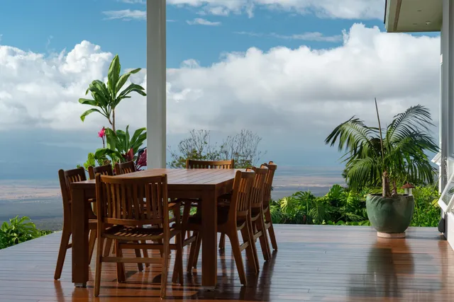 a view of a backyard with swimming pool and sitting area