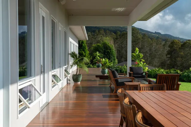 a view of a house with backyard and sitting area
