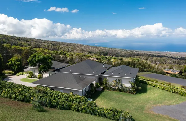 an aerial view of residential houses with outdoor space and river