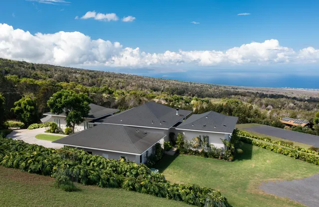 an aerial view of residential houses with outdoor space and river