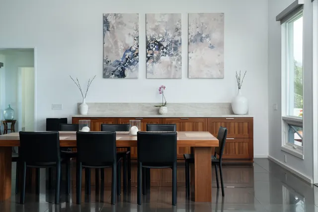 a kitchen with a table chairs and a refrigerator