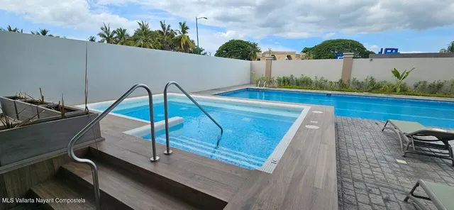 a view of swimming pool with outdoor seating and plants