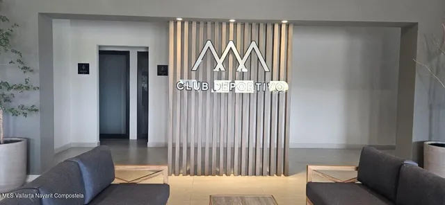 a view of a livingroom with furniture and floor to ceiling window