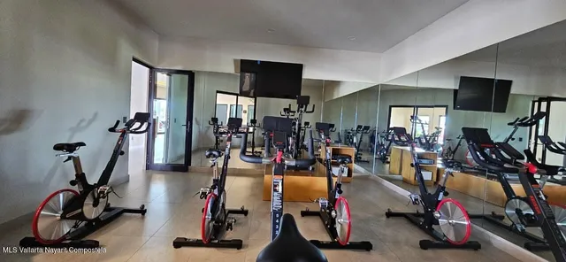a dining room with furniture and a floor to ceiling window