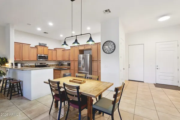 a dining room with a table chairs and a clock