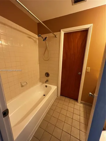 a bathroom with a bathtub and shower