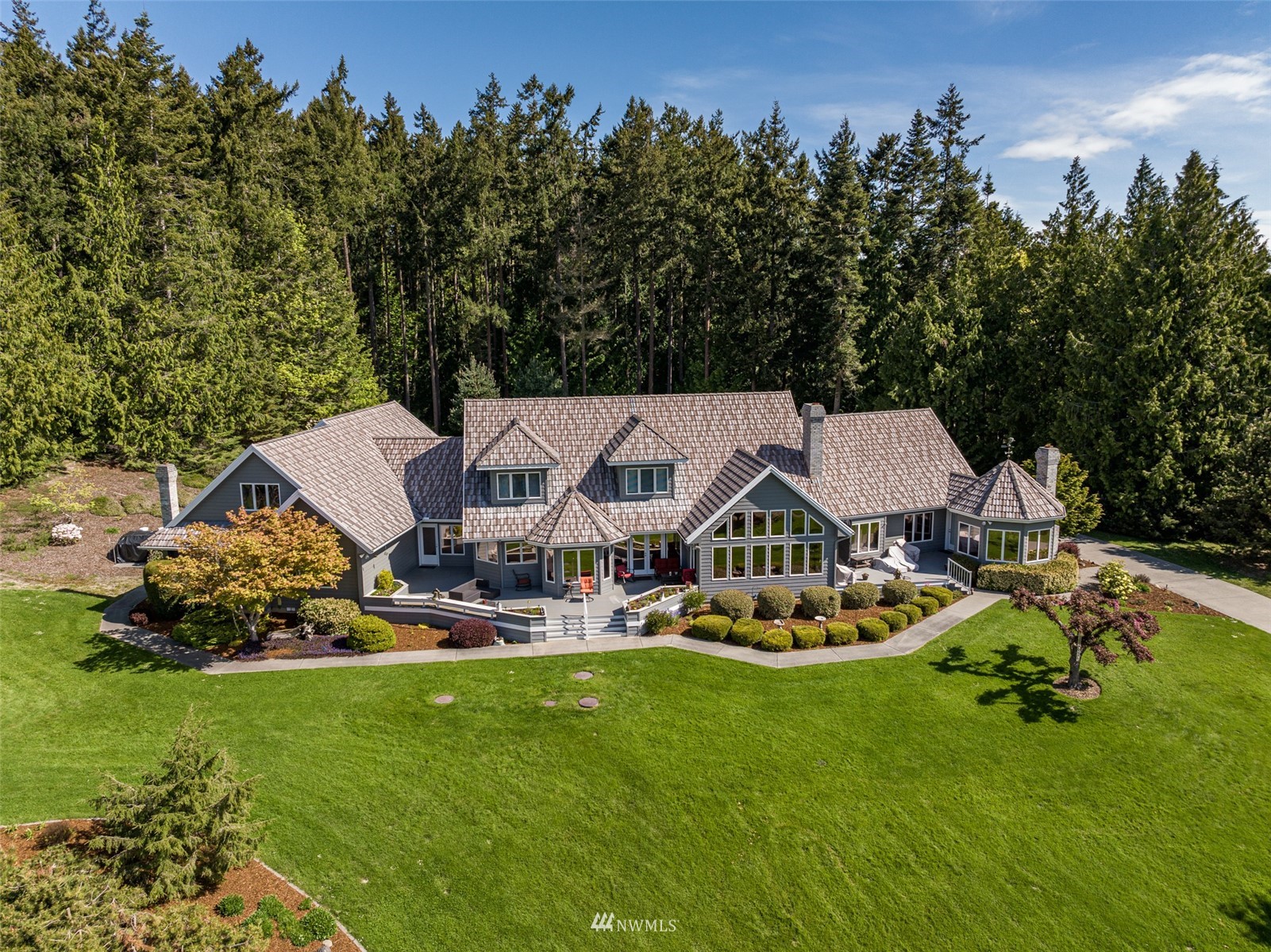 4949 Woodcock Road Sequim, WA 98382 - Photo 1 of 40 an aerial view of a house with garden space and street view