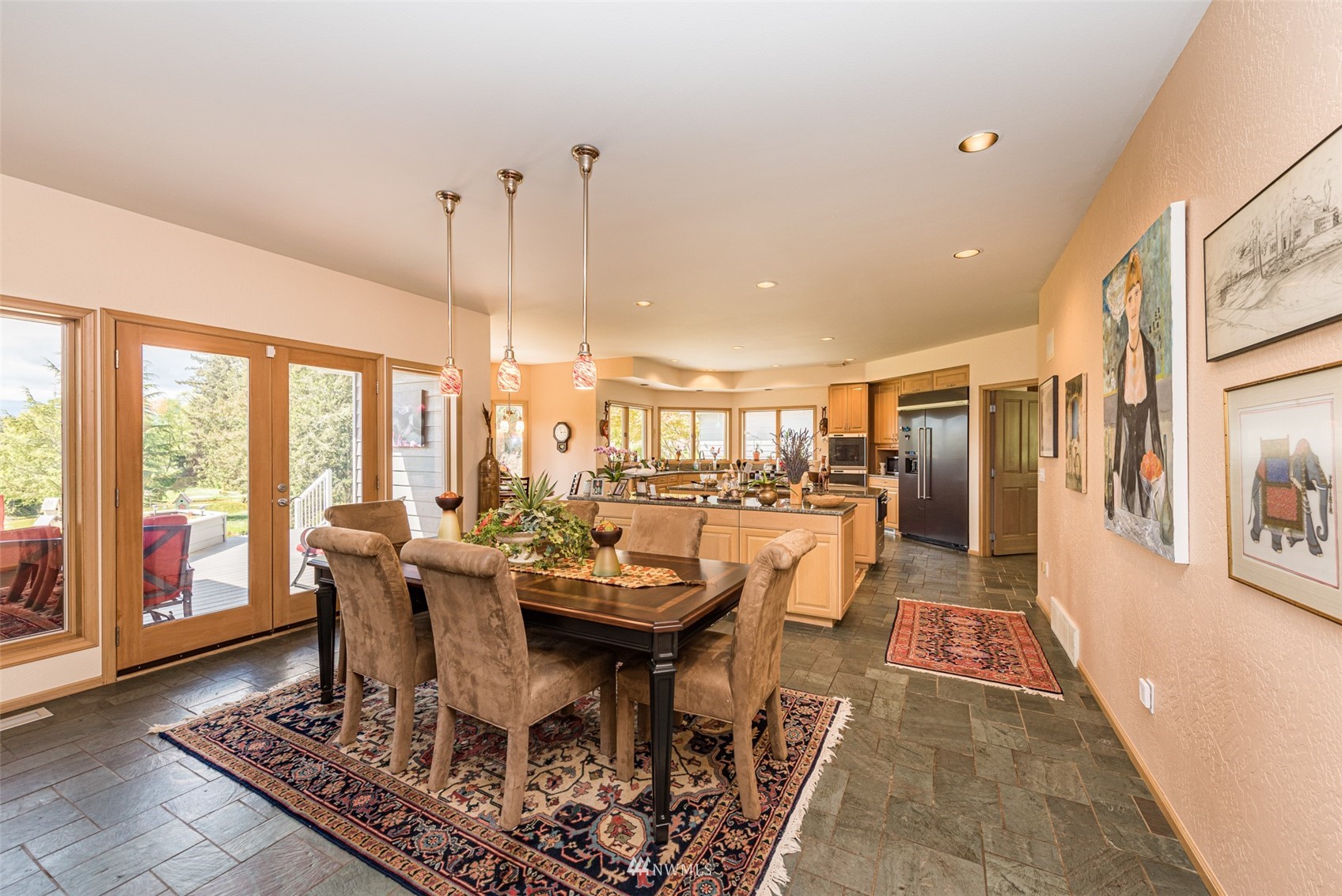 4949 Woodcock Road Sequim, WA 98382 - Photo 11 of 40 a dining room with furniture a rug and a chandelier