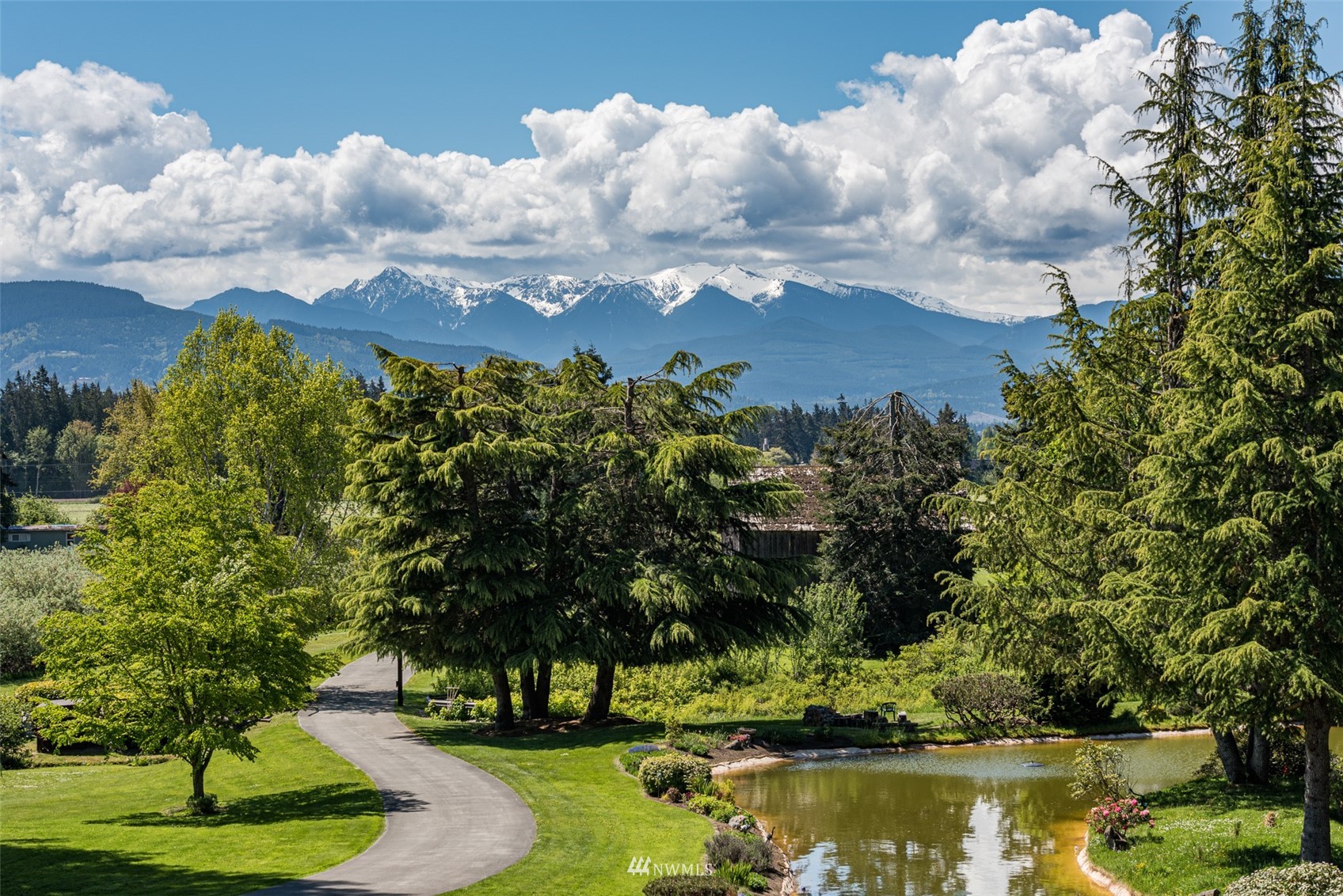 4949 Woodcock Road Sequim, WA 98382 - Photo 13 of 40 a view of a lake with houses in the back