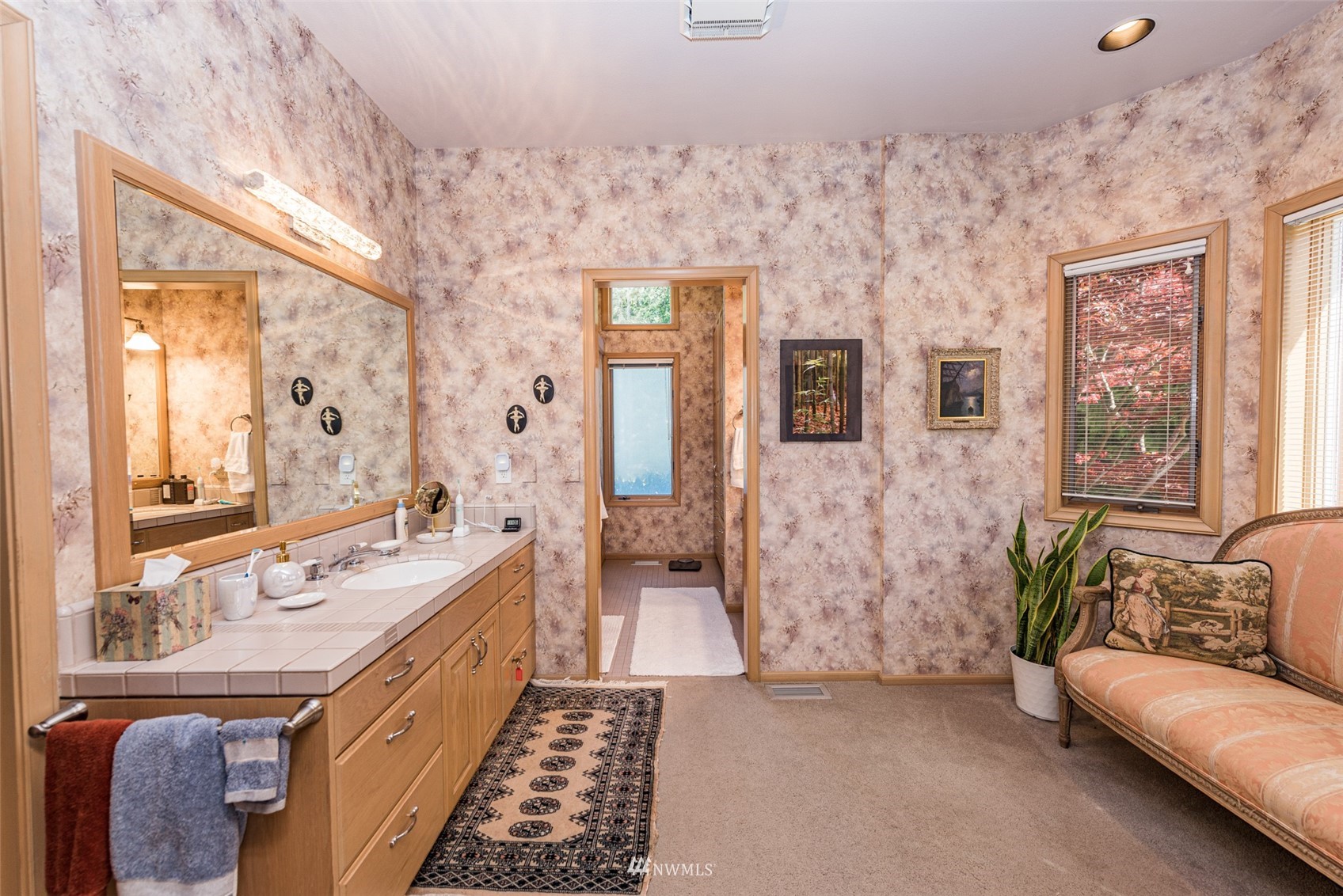 4949 Woodcock Road Sequim, WA 98382 - Photo 19 of 40 a large bathroom with a tub sink and mirror