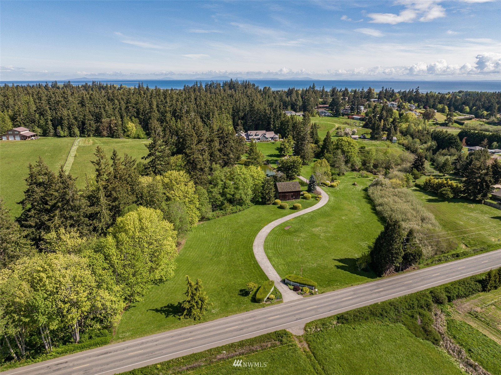 4949 Woodcock Road Sequim, WA 98382 - Photo 2 of 40 an aerial view of a residential houses with outdoor space and trees