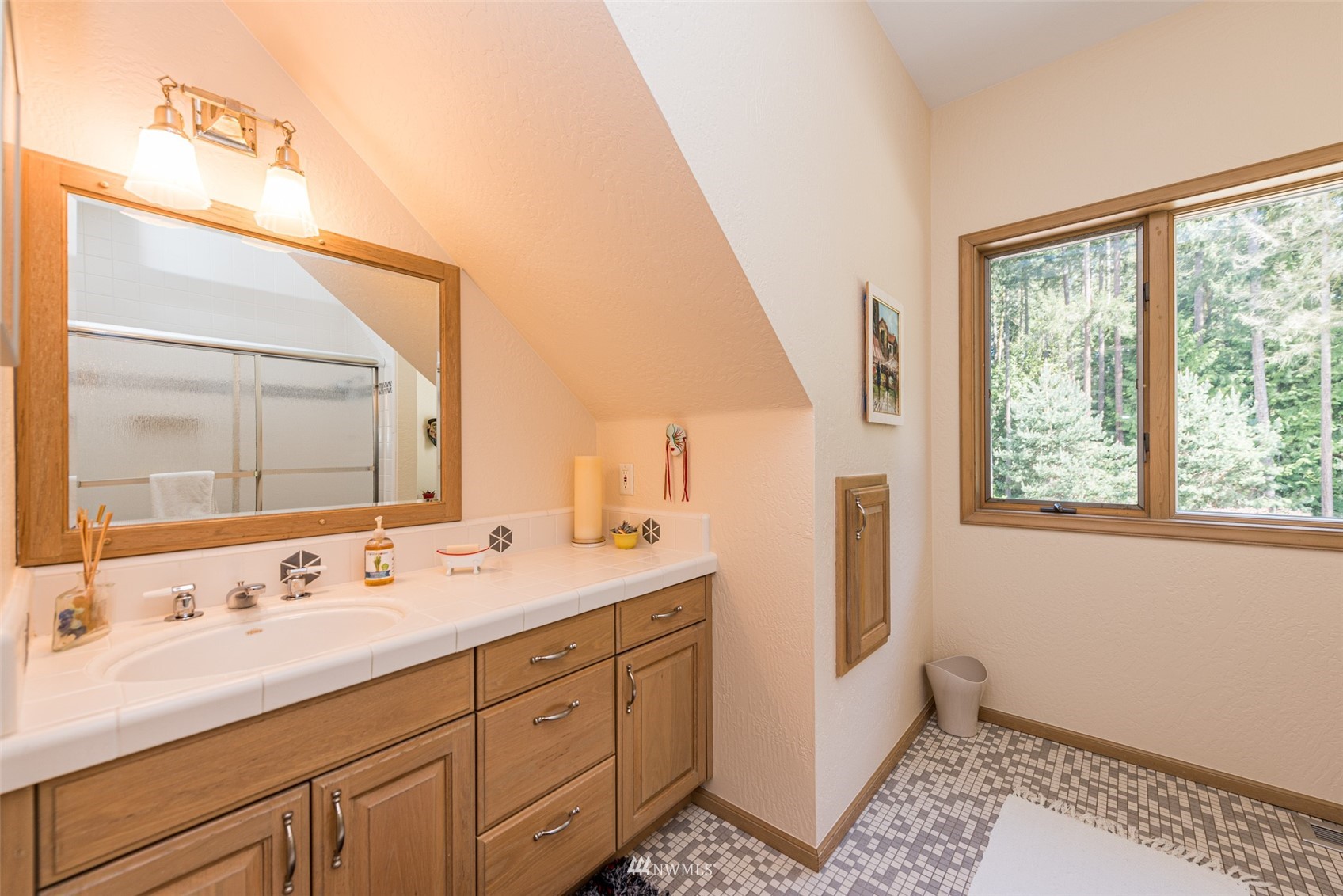 4949 Woodcock Road Sequim, WA 98382 - Photo 28 of 40 a spacious bathroom with double vanity and a mirror