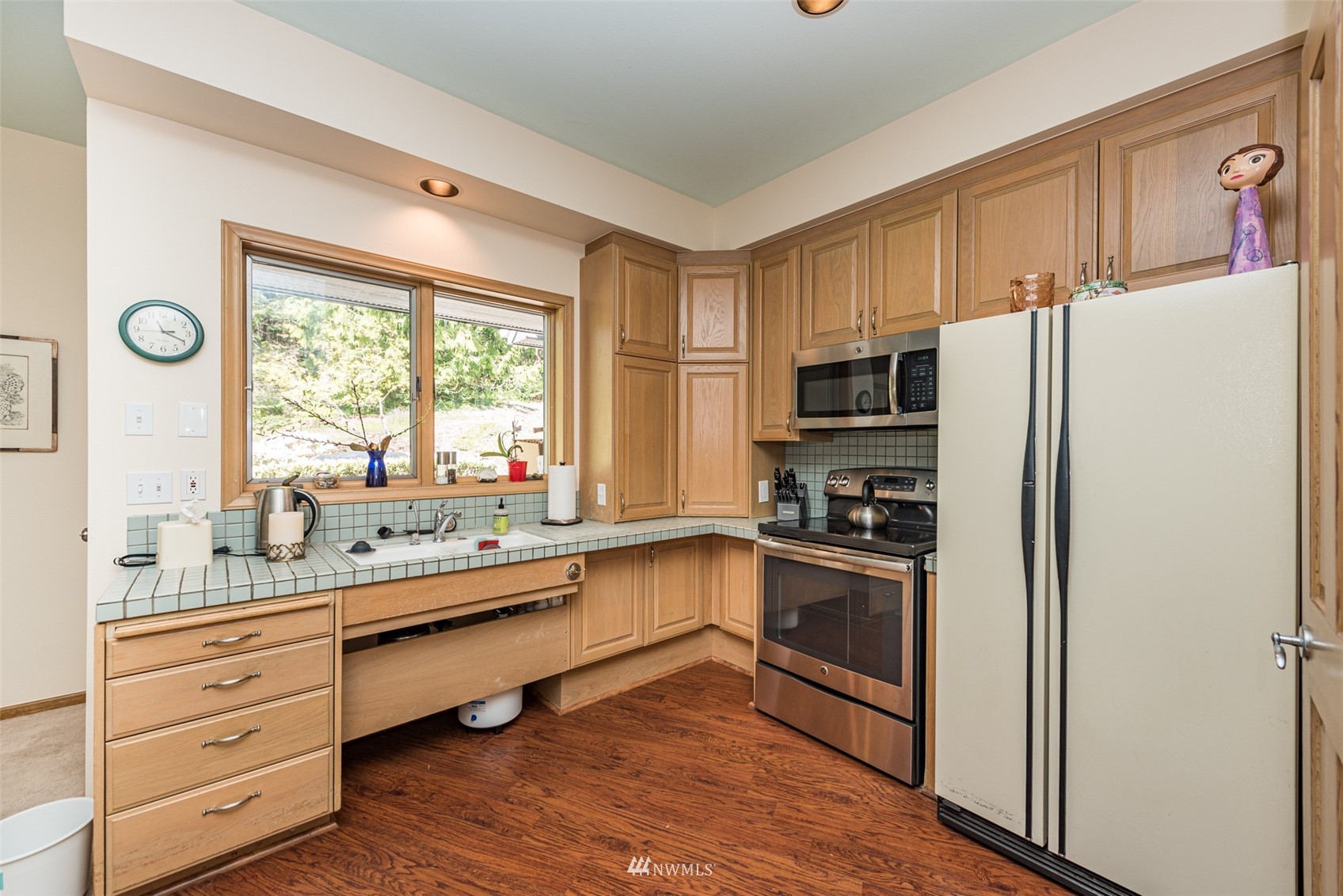 4949 Woodcock Road Sequim, WA 98382 - Photo 32 of 40 a kitchen with granite countertop stainless steel appliances and wooden cabinets
