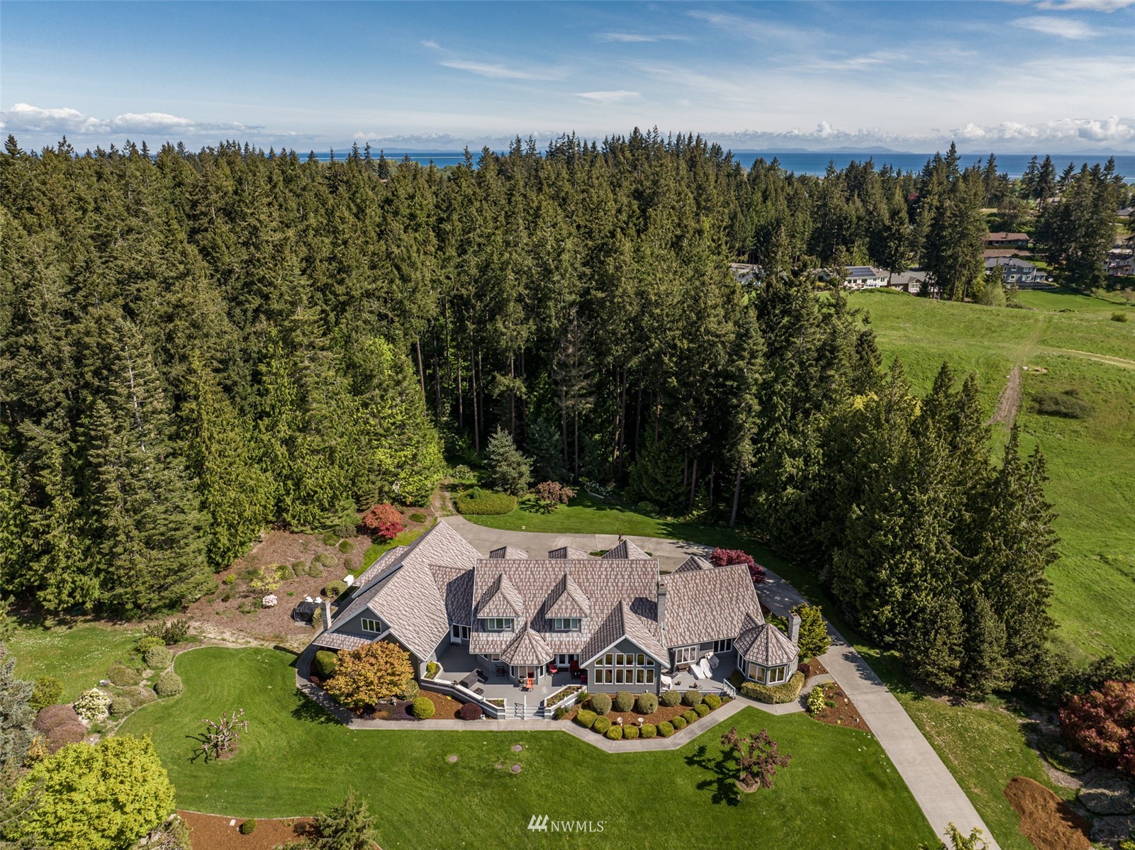 4949 Woodcock Road Sequim, WA 98382 - Photo 36 of 40 an aerial view of a house with yard swimming pool and outdoor seating