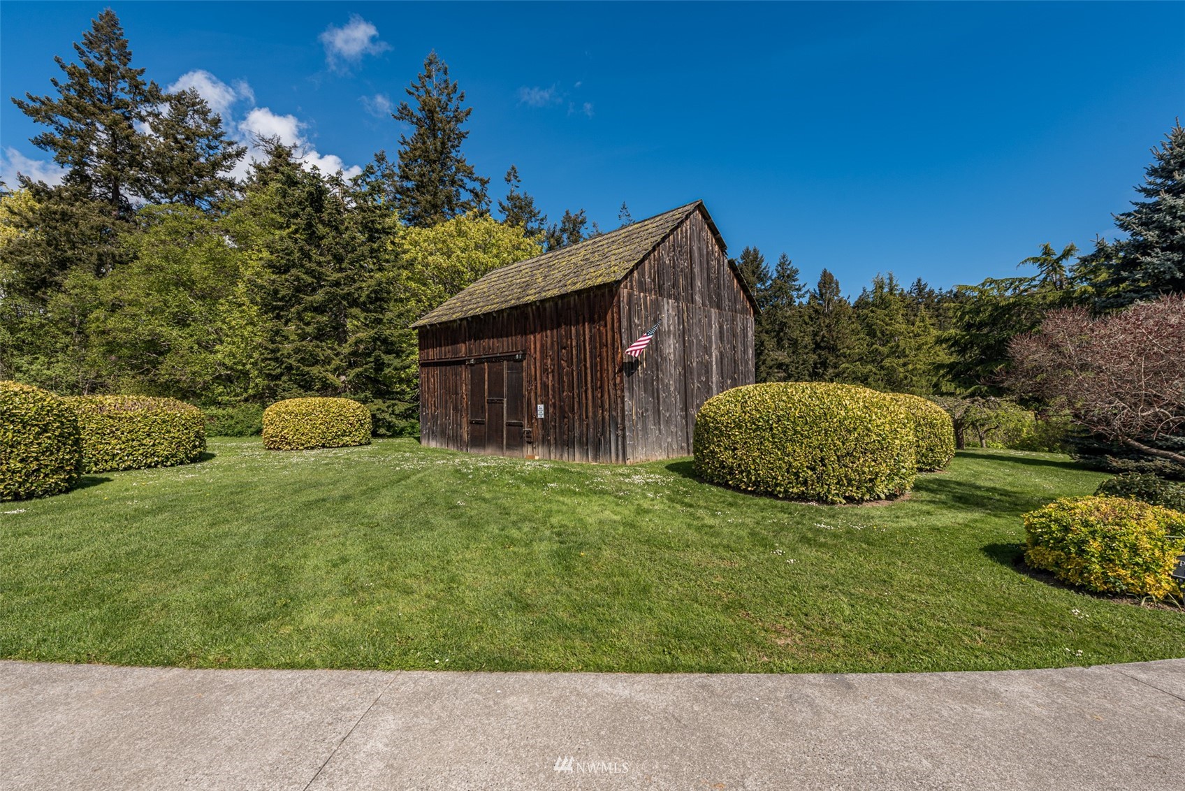 4949 Woodcock Road Sequim, WA 98382 - Photo 37 of 40 a view of a house with a yard and plants