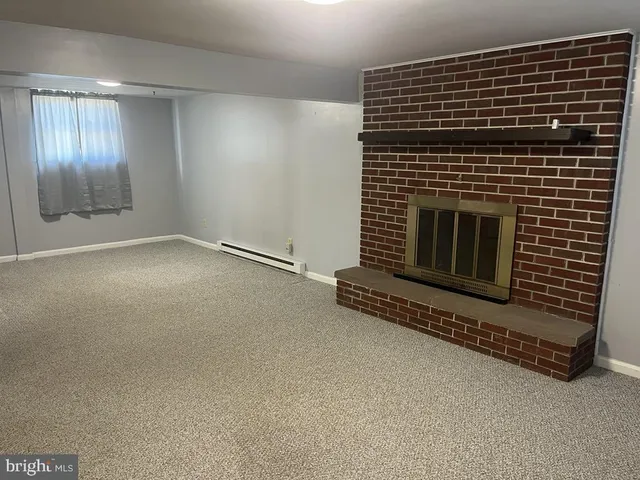 a view of an empty room with a fireplace