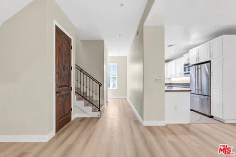 an empty room with wooden floor and fireplace
