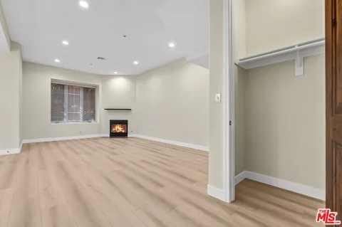 a view of empty room with a fireplace
