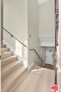 a view of a bedroom with furniture and staircase
