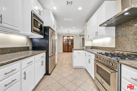a view of staircase with railing and white walls