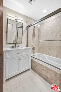 a view of a pathway of a house with wooden fence