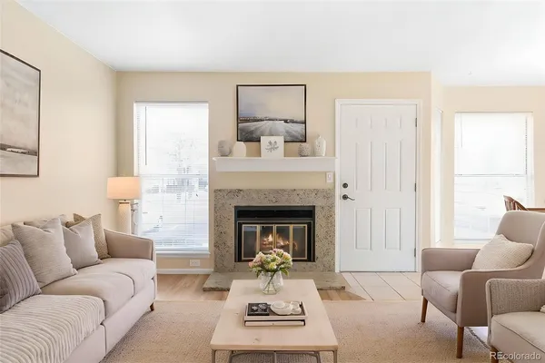 a living room with furniture and a fireplace