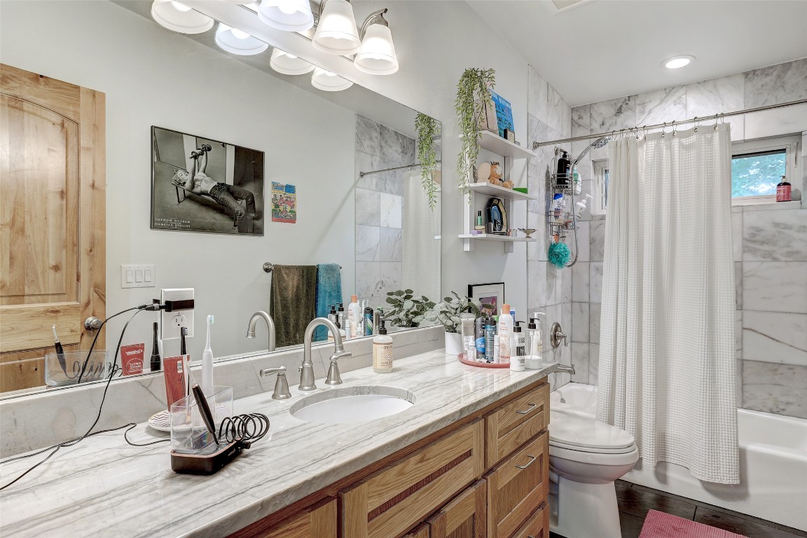 809 East 44th Street Austin, TX 78751 - Photo 38 of 40 Bathroom featuring shower / bath combination with curtain, vanity, and toilet