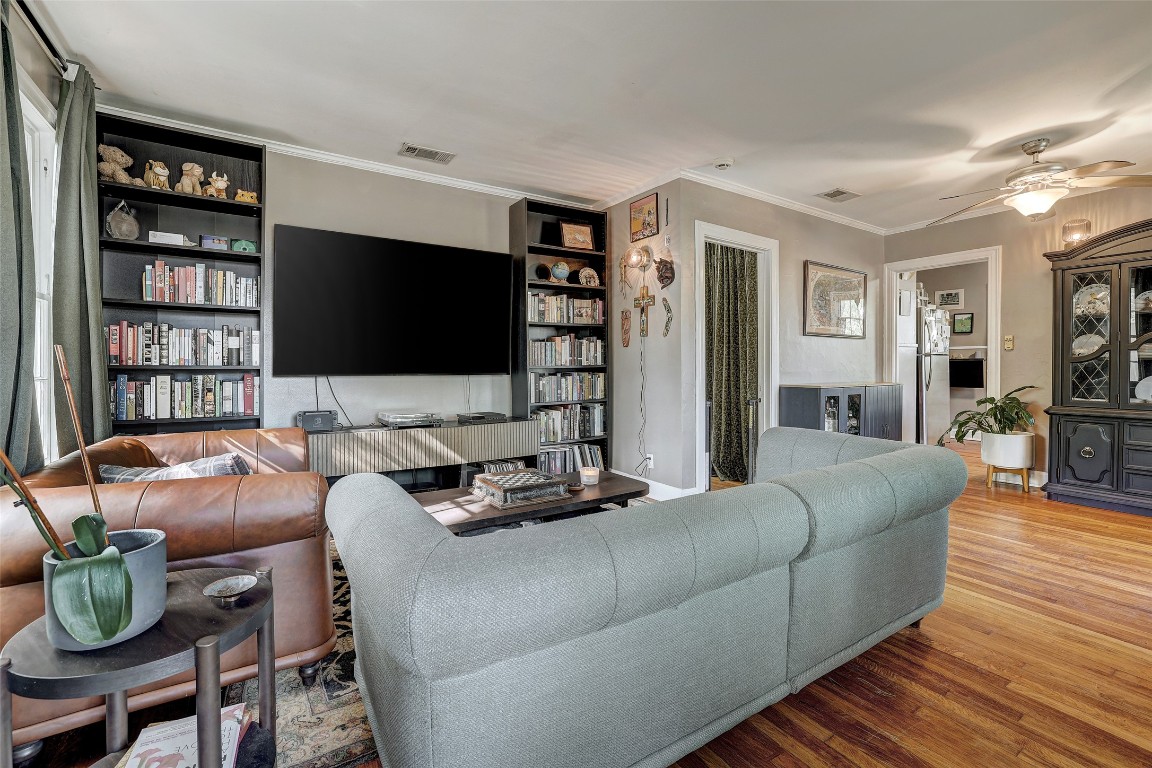 809 East 44th Street Austin, TX 78751 - Photo 6 of 40 Living room featuring a ceiling fan, ornamental molding, wood finished floors, and visible vents