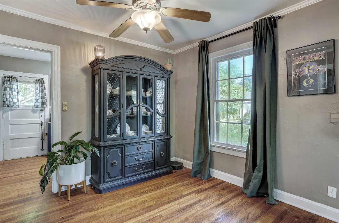 809 East 44th Street Austin, TX 78751 - Photo 10 of 40 Unfurnished room featuring light wood finished floors, ceiling fan, a wealth of natural light, and ornamental molding