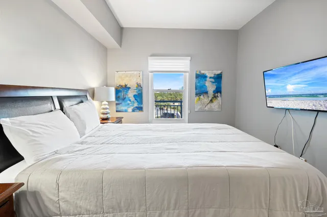 a bedroom with a bed and a painting on the wall