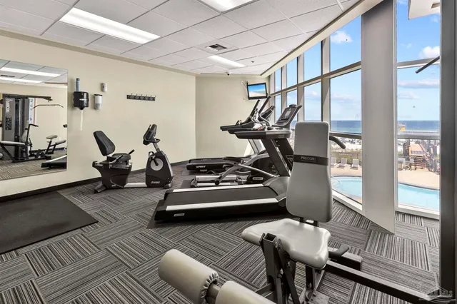a backyard of a house with table and chairs under an umbrella