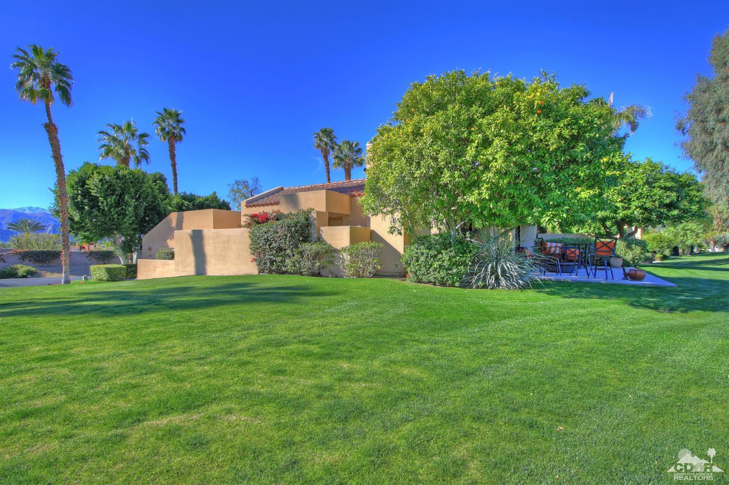 a view of a garden with a building in the background