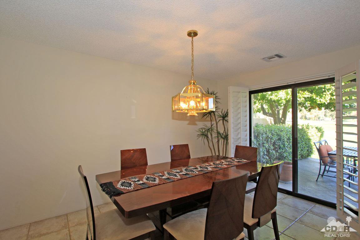 17 Mission Court Rancho Mirage, CA 92270 - Photo 16 of 37 a dining room with furniture a chandelier and wooden floor