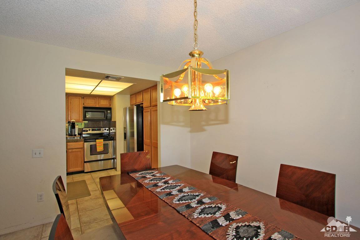 17 Mission Court Rancho Mirage, CA 92270 - Photo 19 of 37 a bedroom with a bed and chandelier