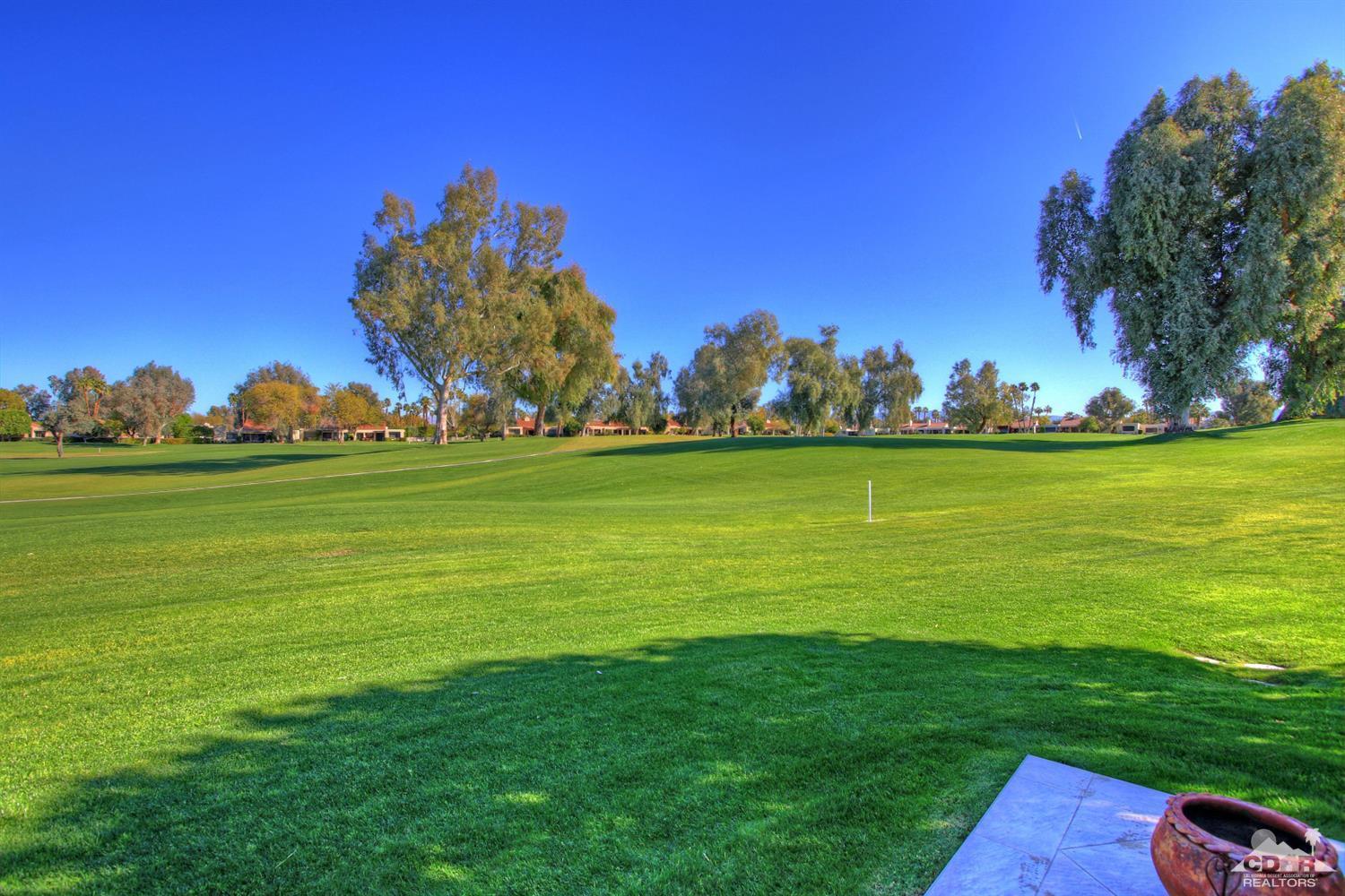 17 Mission Court Rancho Mirage, CA 92270 - Photo 27 of 37 a backyard of a house with lots of green space