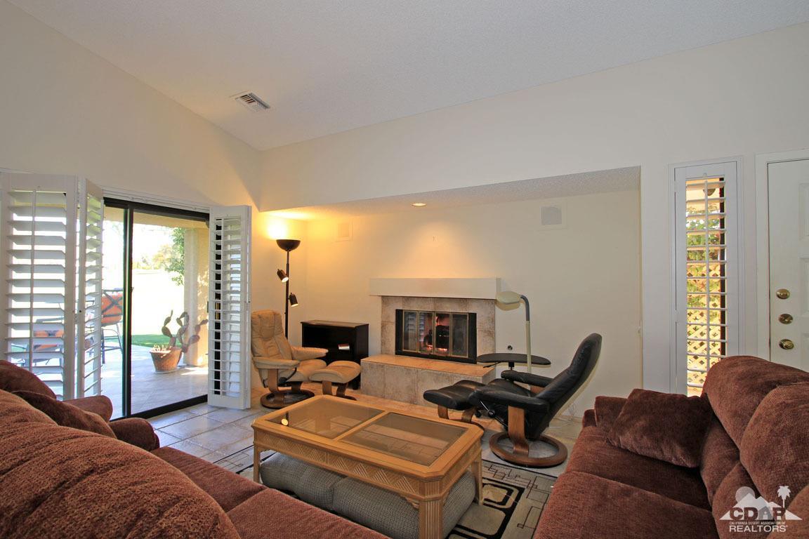 17 Mission Court Rancho Mirage, CA 92270 - Photo 9 of 37 a living room with furniture a fireplace and a large window