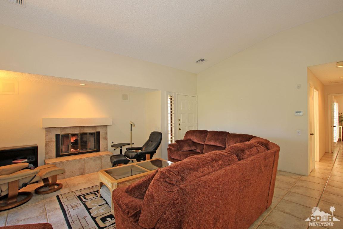 17 Mission Court Rancho Mirage, CA 92270 - Photo 10 of 37 a living room with furniture a fireplace and a flat screen tv