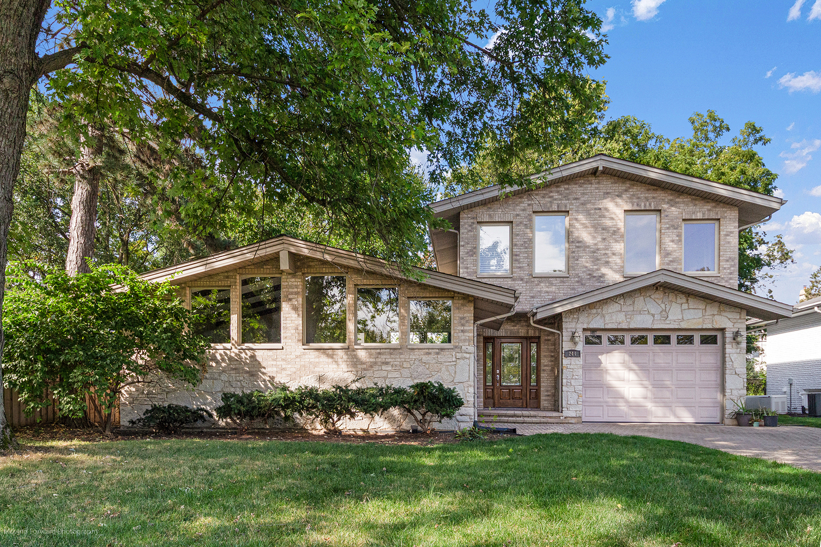 244 North Jackson Road Clarendon Hills, IL 60514 - Photo 1 of 26 a front view of a house with a yard and potted plants
