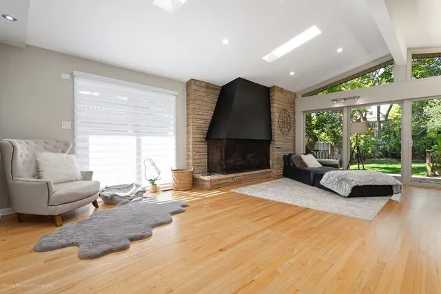 a bedroom with a bed a couch and a large window