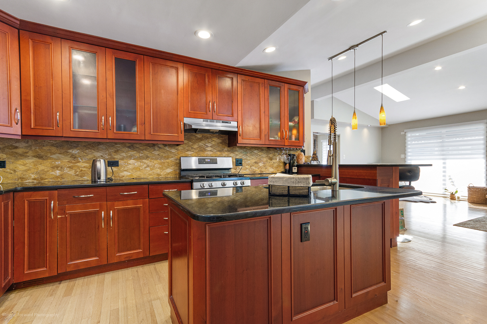 244 North Jackson Road Clarendon Hills, IL 60514 - Photo 7 of 26 a kitchen with kitchen island granite countertop a sink window and cabinets