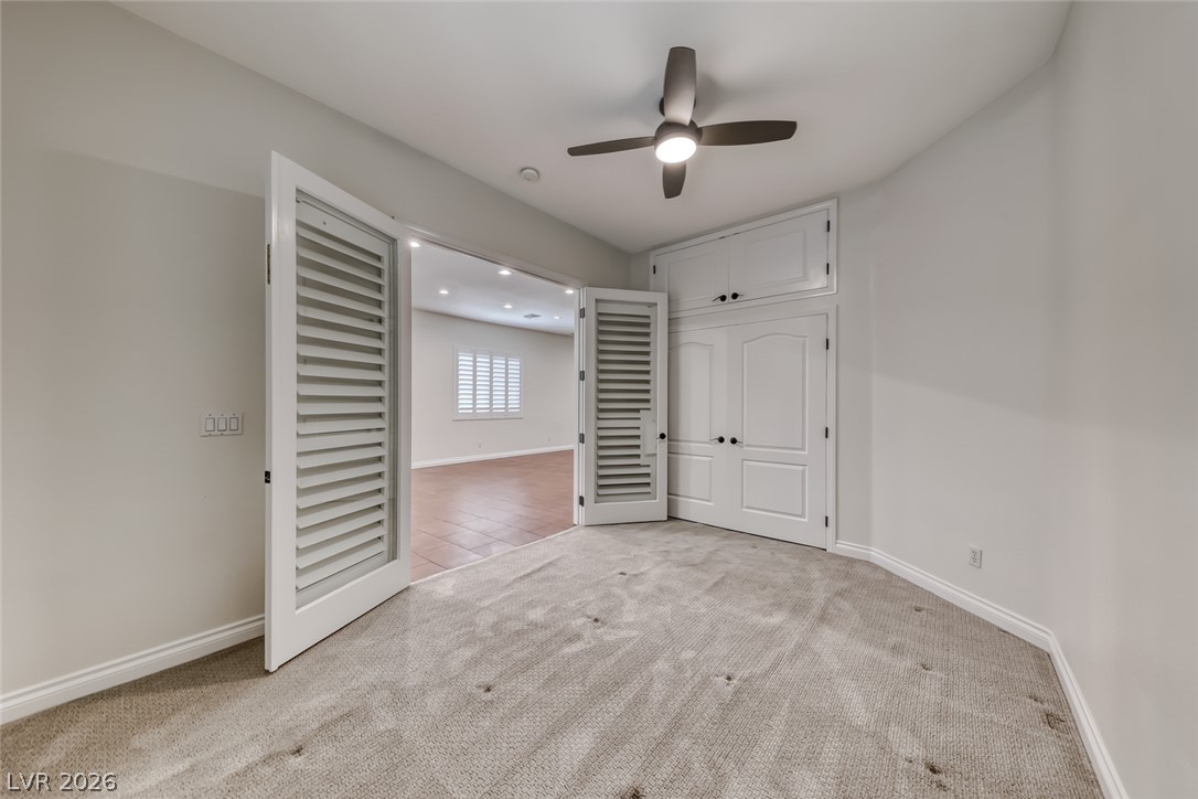 2122 Mooreview Street Henderson, NV 89012 - Photo 24 of 44 A versatile room presents plush carpeting and convenient built-in storage with louvered double doors.