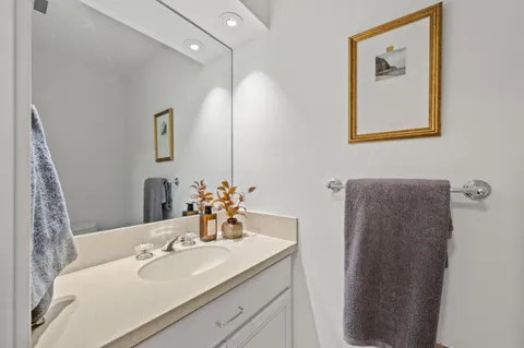 a bathroom with a sink mirror and window