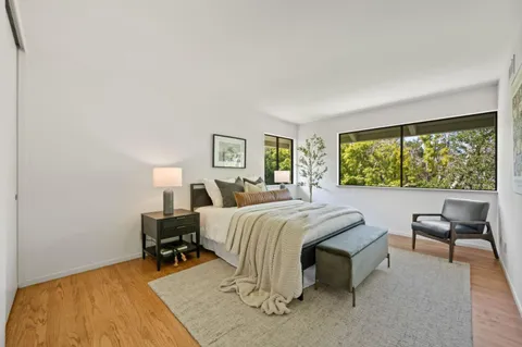 a bedroom with bed and painting on the wall