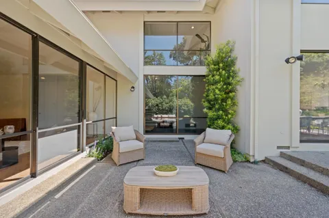 a patio with yard glass top table and chairs