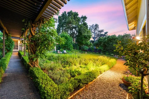 a backyard of a house with table and chairs