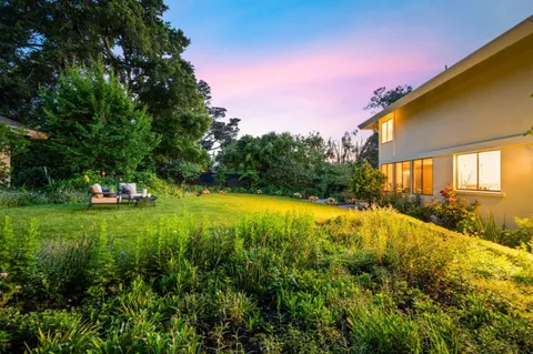 a view of a house with a backyard patio and swimming pool