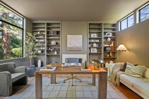 a living room with furniture a rug and a large window